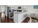 Modern kitchen with white cabinets, stainless steel appliances, and spacious island, perfect for cooking at 10886 Bayfield Way, Parker, CO 80138