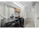 Modern laundry room featuring Samsung front load washer and dryer and oak cabinets at 10886 Bayfield Way, Parker, CO 80138