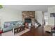 Spacious living room with a stone fireplace, hardwood floors, and comfortable seating at 10886 Bayfield Way, Parker, CO 80138