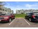 Parking spots in front of townhomes beneath a bright blue sky at 10886 Bayfield Way, Parker, CO 80138