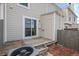 Exterior back patio with sliding glass doors and a wooden fence at 10886 Bayfield Way, Parker, CO 80138