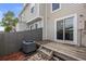 Cozy back patio with wooden fence and sliding glass doors to home interior at 10886 Bayfield Way, Parker, CO 80138