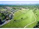 A beautiful aerial view shows a walking path, green field, and neighborhood of homes in the distance at 290 Pierce St, Lakewood, CO 80226