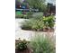 Backyard featuring manicured garden beds, shrubbery, and trimmed lawns at 290 Pierce St, Lakewood, CO 80226