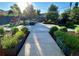 Landscaped backyard featuring decorative shrubbery and a walkway at 290 Pierce St, Lakewood, CO 80226