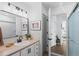Bathroom with neutral-toned walls, framed mirror, and a glass-enclosed shower at 290 Pierce St, Lakewood, CO 80226