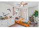 Bright bedroom features a ceiling fan, wood floors, and a large window at 290 Pierce St, Lakewood, CO 80226
