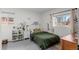 bedroom with dinosaur theme, built-in shelving, and green bedding at 290 Pierce St, Lakewood, CO 80226