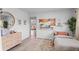 Bright bedroom with stylish decor, wood floors, and a view into the living room at 290 Pierce St, Lakewood, CO 80226