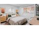 Bright bedroom with a queen bed, neutral tones, and two windows letting in natural light at 290 Pierce St, Lakewood, CO 80226