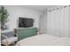 Stylish bedroom with a green dresser, decorative accents, and ample natural light at 290 Pierce St, Lakewood, CO 80226