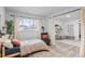 Charming bedroom featuring natural light, a cozy chair, and a doorway to another room at 290 Pierce St, Lakewood, CO 80226