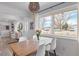 Dining area with a wooden table, white chairs, and a view of the street at 290 Pierce St, Lakewood, CO 80226