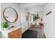 Bright entryway featuring wood accents, a round mirror, and a view into the dining area at 290 Pierce St, Lakewood, CO 80226