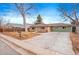 Front view of a charming ranch home with a large yard at 290 Pierce St, Lakewood, CO 80226