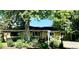 Charming single-story home with brick and siding, lush landscaping, and mature trees at 290 Pierce St, Lakewood, CO 80226