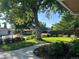 Landscaped front yard featuring a mature tree and a well-manicured lawn at 290 Pierce St, Lakewood, CO 80226