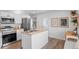 Well-lit kitchen featuring stainless steel appliances, island, and modern finishes at 290 Pierce St, Lakewood, CO 80226
