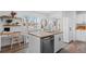 Bright kitchen with center island, white cabinets, and a built-in desk area at 290 Pierce St, Lakewood, CO 80226