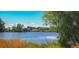 Scenic view of the lake with a gazebo in the distance and green trees at 290 Pierce St, Lakewood, CO 80226