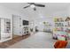 Spacious living room with a ceiling fan, large area rug, and access to multiple rooms at 290 Pierce St, Lakewood, CO 80226