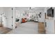Bright living room featuring an area rug, cozy sofa, and access to other rooms at 290 Pierce St, Lakewood, CO 80226