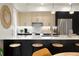 Modern kitchen with light wood cabinets, stainless steel appliances, and a breakfast bar at 4823 W 10Th Ave, Denver, CO 80204