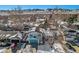 An aerial view showcasing a house in a snow-covered neighborhood with mountain views at 2527 S Coors St, Lakewood, CO 80228