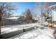 Spacious backyard with raised garden beds and snow cover at 2527 S Coors St, Lakewood, CO 80228