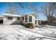 Snowy backyard with raised garden beds and storage shed at 2527 S Coors St, Lakewood, CO 80228