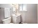 Clean bathroom with updated vanity and patterned wallpaper at 2527 S Coors St, Lakewood, CO 80228