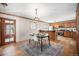 Kitchen with wood cabinets, an island, and a dining area at 2527 S Coors St, Lakewood, CO 80228