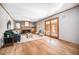 Spacious living room featuring hardwood floors, a fireplace, and French doors at 2527 S Coors St, Lakewood, CO 80228