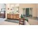 Bright bathroom with double sinks, wooden vanity, and a soaking tub at 4143 Da Vinci Dr, Longmont, CO 80503