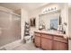 Bathroom featuring a single sink, framed mirror and glass shower, with a decorative ladder at 4143 Da Vinci Dr, Longmont, CO 80503
