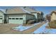 Exterior view of a well-maintained home with a two-car garage and snowy landscaping at 4143 Da Vinci Dr, Longmont, CO 80503