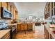 Modern kitchen with stainless steel appliances and hardwood floors seamlessly connects to the living room creating a cohesive living space at 4143 Da Vinci Dr, Longmont, CO 80503