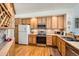 Traditional kitchen features wooden cabinetry, stainless steel appliances, and hardwood floors at 4143 Da Vinci Dr, Longmont, CO 80503