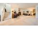 A versatile living room space with stairs, desk, and cozy seating area with neutral carpeting at 4143 Da Vinci Dr, Longmont, CO 80503