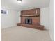 Finished basement with a brick fireplace and neutral carpet at 12516 E Alaska Ave, Aurora, CO 80012