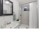 Clean bathroom with a shower/tub combo, white vanity, and a framed mirror at 12516 E Alaska Ave, Aurora, CO 80012