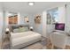 Spacious bedroom with a comfortable bed, built-in shelving, and a workspace at 12516 E Alaska Ave, Aurora, CO 80012
