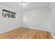 Well-lit bedroom featuring hardwood floors and a window at 12516 E Alaska Ave, Aurora, CO 80012