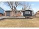 Brick ranch home with updated dark gray siding, landscaping, and a spacious yard at 12516 E Alaska Ave, Aurora, CO 80012