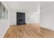 Spacious living room featuring hardwood floors and a brick fireplace at 12516 E Alaska Ave, Aurora, CO 80012