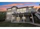 Backyard view features second story deck with stairs to patio with outdoor lighting at 423 N Snowmass Cir, Superior, CO 80027