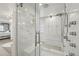 Bright bathroom features a glass shower with dual heads and a bench, complemented by white subway tile and storage at 423 N Snowmass Cir, Superior, CO 80027