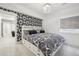 Stylish bedroom featuring a patterned accent wall, plush bedding, and a decorative chandelier at 423 N Snowmass Cir, Superior, CO 80027