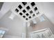 Dramatic ceiling design with coffered panels, ambient lighting and a decorative chandelier complements the room's elegance at 423 N Snowmass Cir, Superior, CO 80027