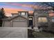 Charming two-story stone home featuring a three-car garage and a covered front entry at 423 N Snowmass Cir, Superior, CO 80027